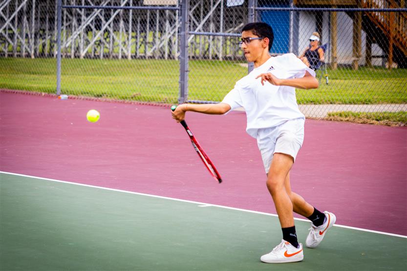 A tennis player hits the ball